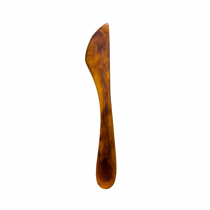 Amber brown resin knife with organic swirl and gradient pattern on a white background