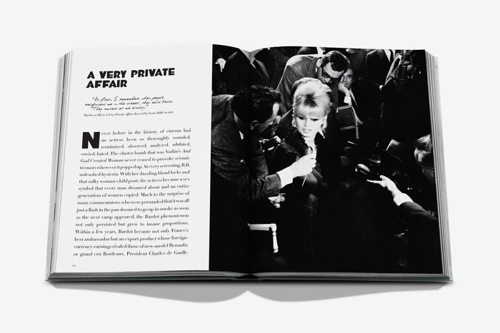 Open book showing a black and white photograph of a woman being filmed by a cameraman.