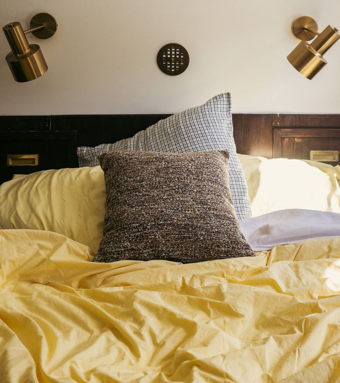 The Socialite Family Carino square cushion in brown and green tweed-effect fabric, 45x45cm, styled in a room setting 2