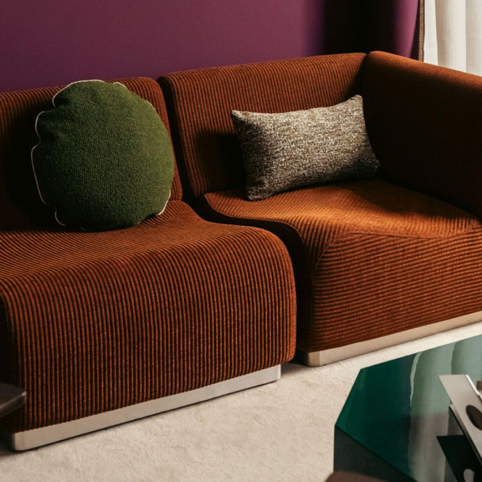 The Socialite Family Carino rectangular cushion in brown and green tweed-effect fabric, styled in a room setting