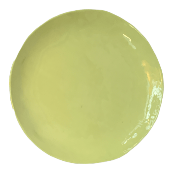 Birds eye view of a green ceramic side plate.