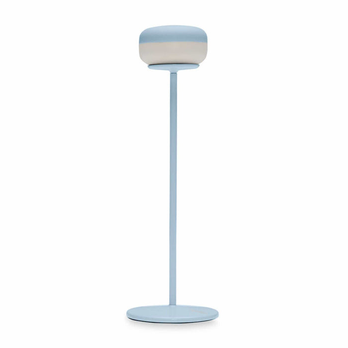 Light blue lamp with a cylindrical shade on a white background